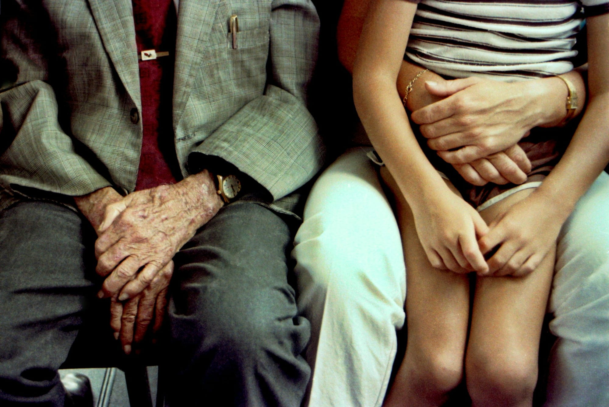 An older man and a young child sitting side by side